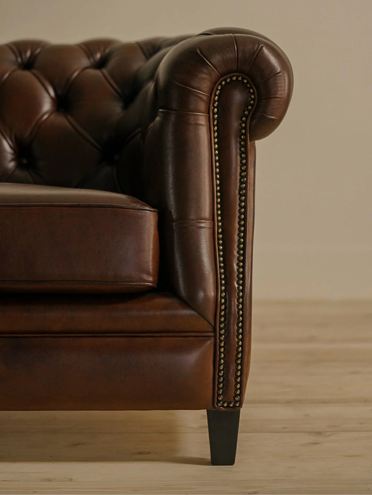Brown leather Chesterfield sofa with deep-buttoned back and rolled arm by Chester's India