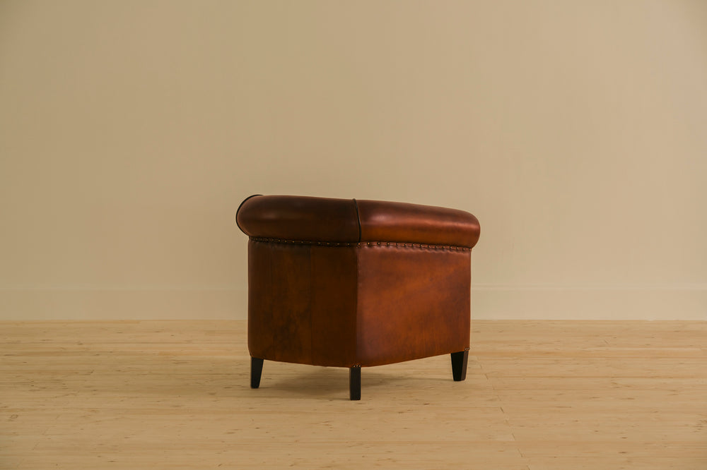 Brown leather armchair on a beige background