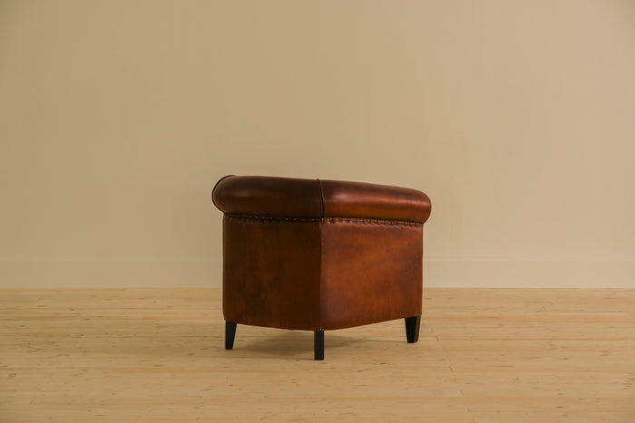 Brown leather armchair on a beige background