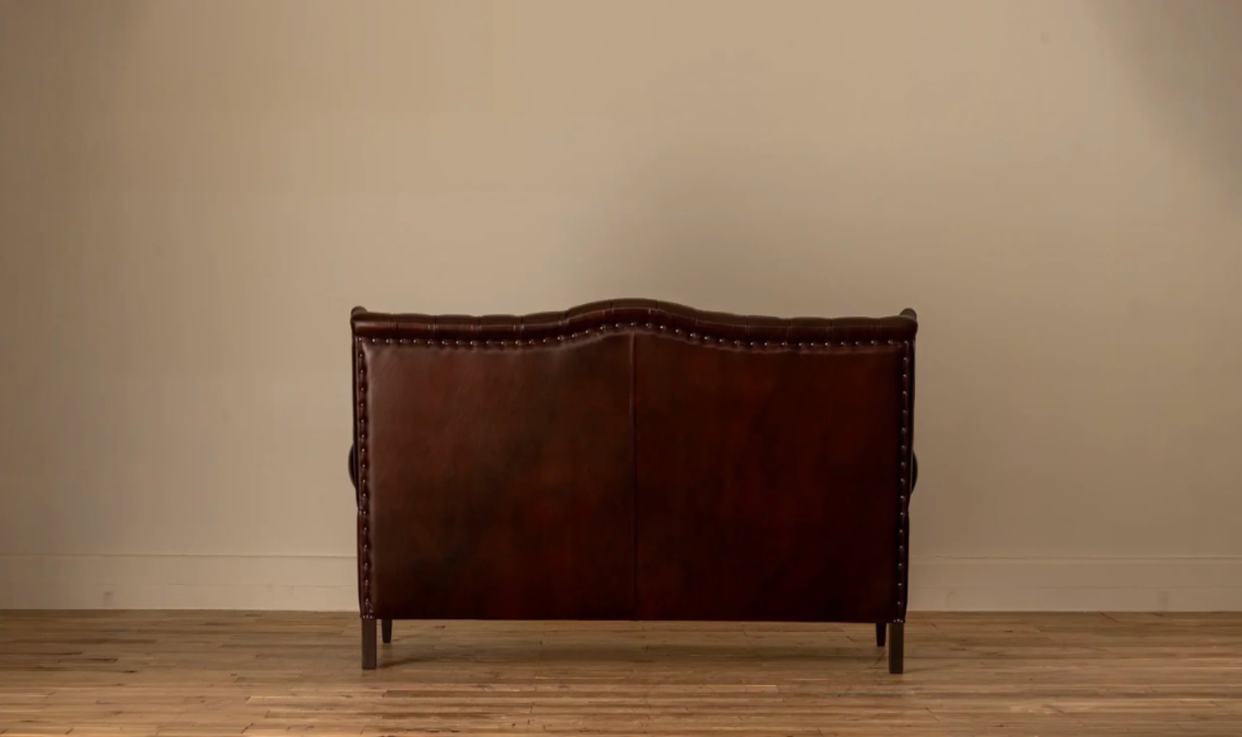 Back view: Rear view of the James Chesterfield 3-Seater Sofa showing the tufted leather back panel with nailhead trim along the edges.