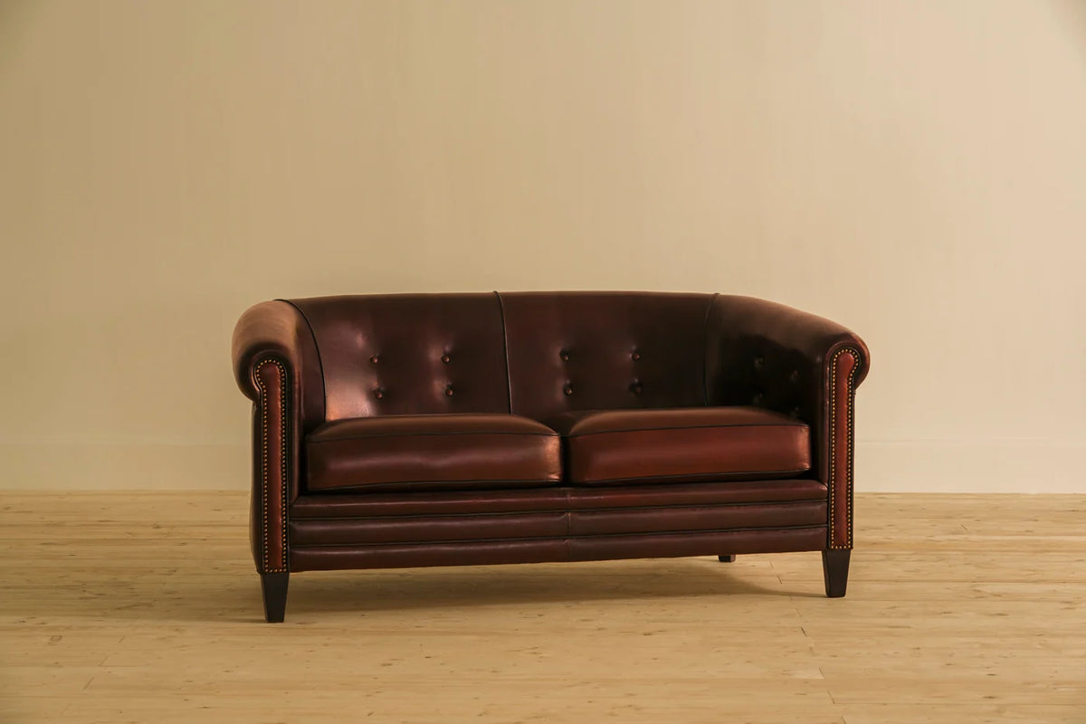 Brown Saheb 2-seater sofa in Shadow Claret leather with button tufting and brass tacking, inspired by 19th century club style. A Chester's India heritage classic in solid wood and full grain leather.