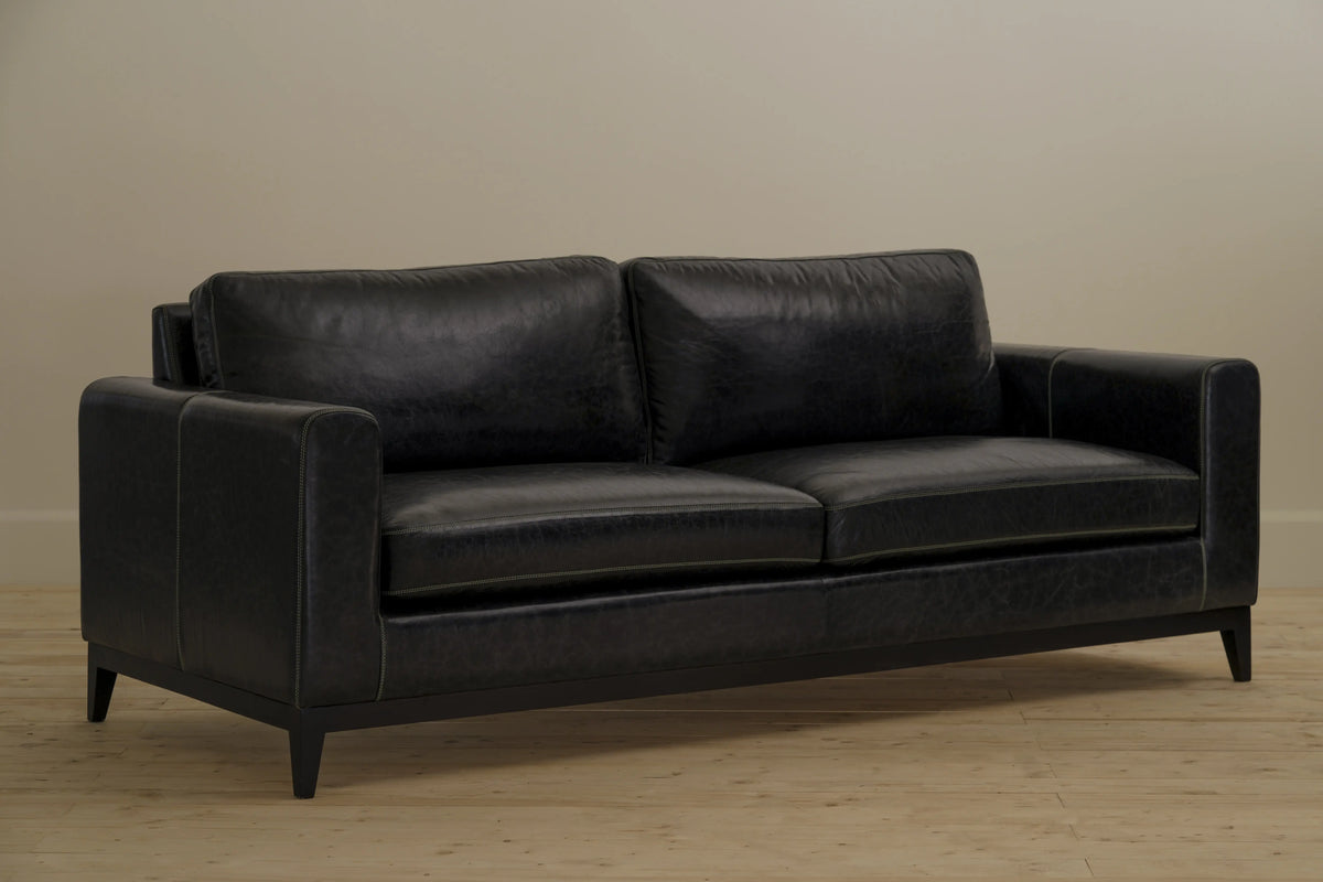 Diplomat 3-seater sofa in Vintage Stone leather with sleek lines and a straight-edged modern profile. Handcrafted by Chester's India using teak wood and precision joinery.