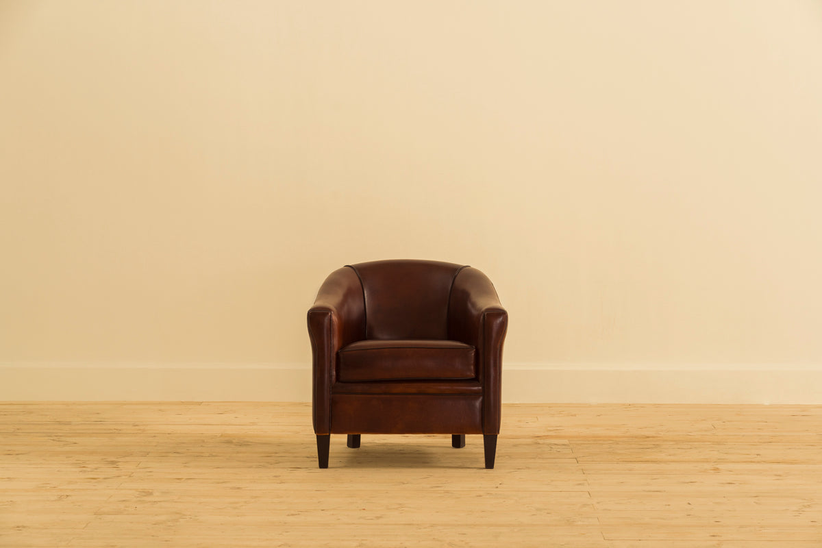 Duchess Single Seater leather armchair by Chester’s India, featuring a gently tapered back, softly flared arms and hand-finished wooden legs.