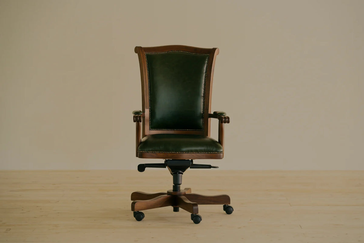 Heritage swivel chair with an exposed solid teak frame and Shadow Bottle Green full grain leather upholstery, a nod to classic colonial craftsmanship. Handcrafted by Chester's India.
